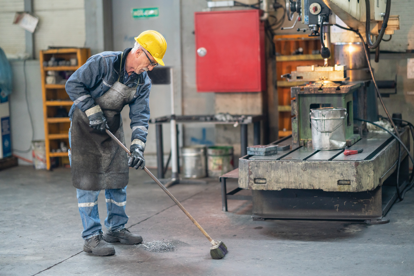 Worker cleaning industrial dirt